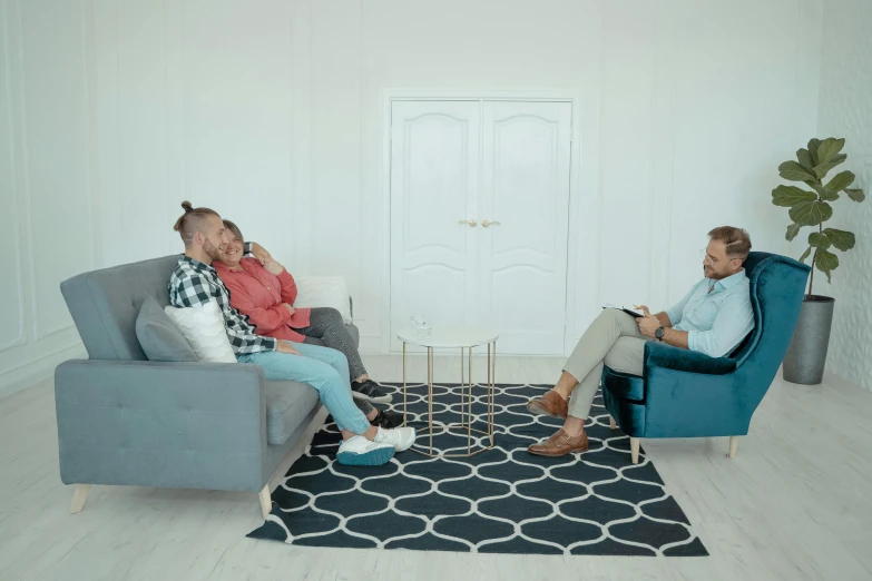two men sitting on a couch in a living room, by Adam Marczyński, pexels, hurufiyya, 3 - piece, in white room, low quality footage, looking at each other mindlessly