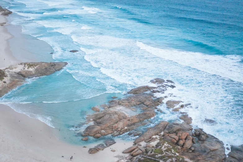 a large body of water next to a sandy beach, pexels contest winner, lachlan bailey, ocean spray, high angle, sza