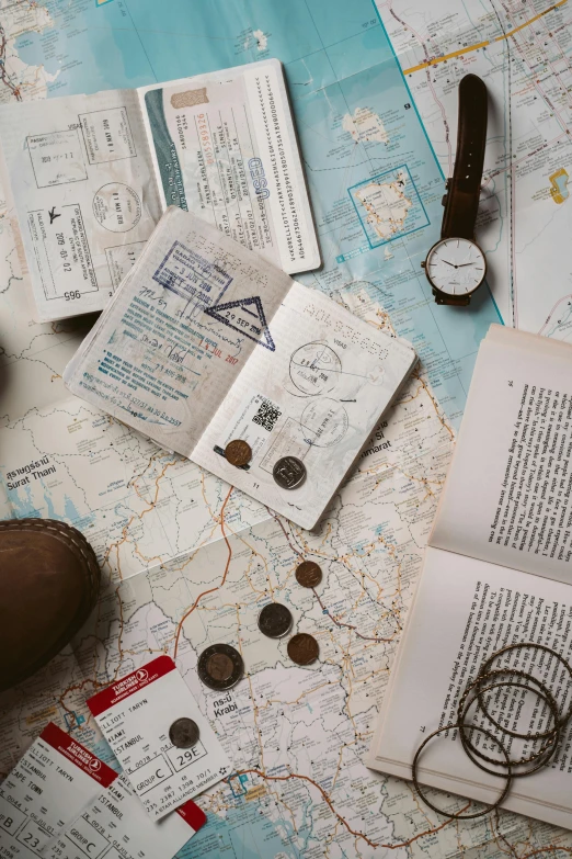 a pair of brown boots sitting on top of a map, passport photo, flatlay book collection, compass, instagram story