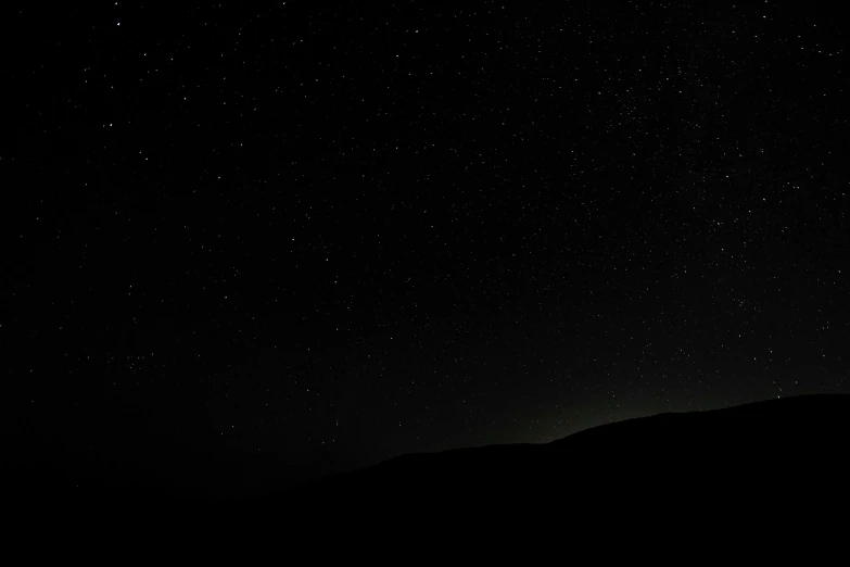 a dark sky filled with lots of stars, by Kristian Zahrtmann, unsplash, minimalism, black mountains, cloudless-crear-sky, minimal background, on black background