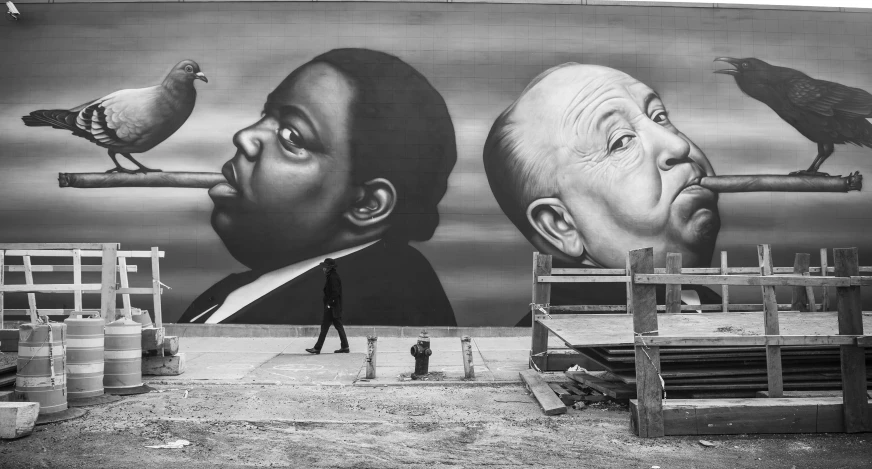 a man that is standing in front of a mural, a black and white photo, inspired by Larry Fink, pexels contest winner, odeith, notorious b i g, a painting of two people, giant and fat