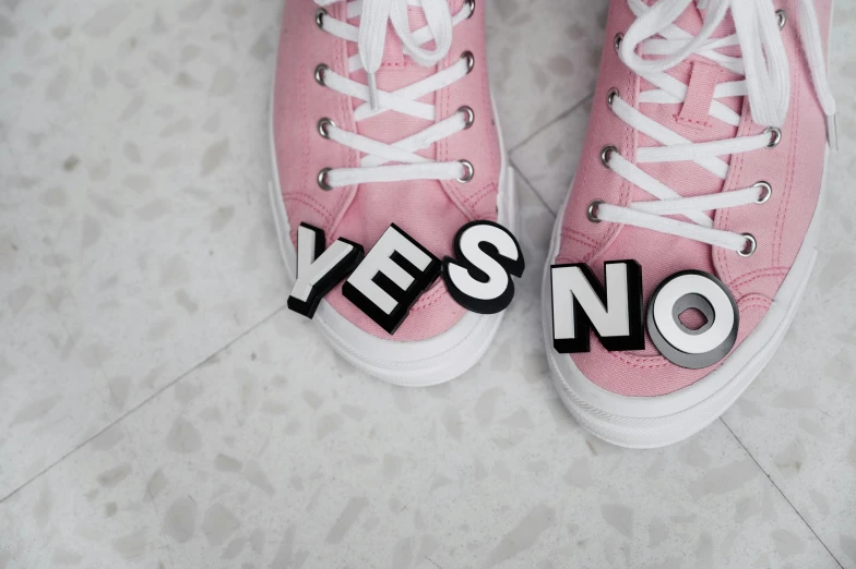 a pair of pink sneakers with yes no written on them, trending on pexels, neoism, die antwoord ( yolandi visser ), leather shoes, felt, thumbnail