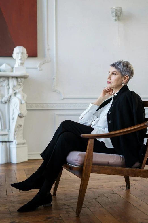 a woman sitting in a chair in a room, inspired by Marie-Gabrielle Capet, trending on unsplash, baroque, short grey hair, formal portrait, androgynous male, john pawson