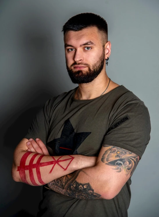 a man with a tattoo on his arm, a tattoo, by Adam Marczyński, hurufiyya, khabib, headshot profile picture, lgbtq, profile image