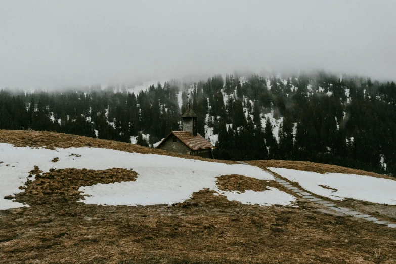 a house sitting on top of a snow covered hill, pexels contest winner, renaissance, overcast gray skies, chalet, religious, album cover