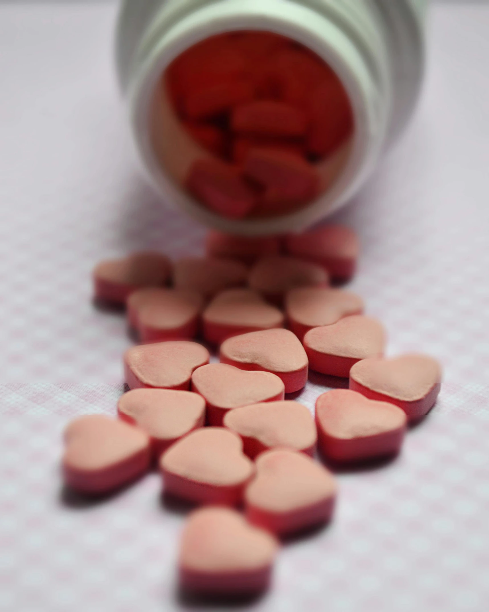 pills spilling out of a bottle on a table, by Emma Andijewska, pexels, antipodeans, red hearts, covered with pink marzipan, thumbnail, 15081959 21121991 01012000 4k