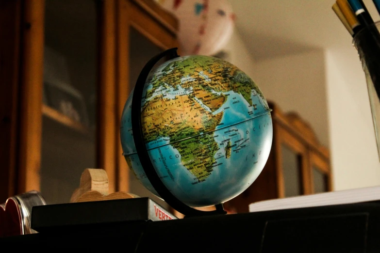 a small globe sitting on top of a desk