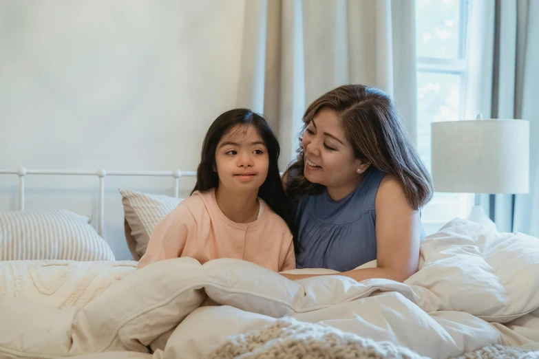 a woman sitting next to a little girl on a bed, pexels contest winner, hurufiyya, cindy avelino, avatar image, confident looking, super high resolution