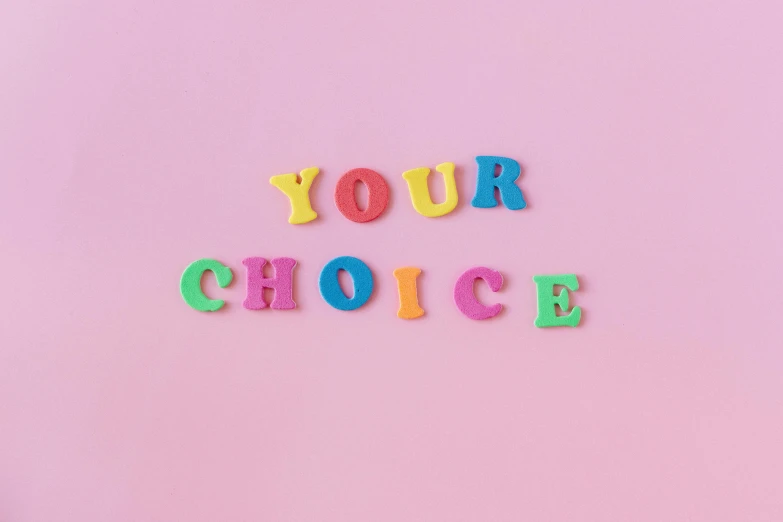 colorful letters spelling your choice on a pink background, by Nicolette Macnamara, pexels contest winner, synchromism, y2k aesthetic, inspirational quote, nathan for you, on a pale background
