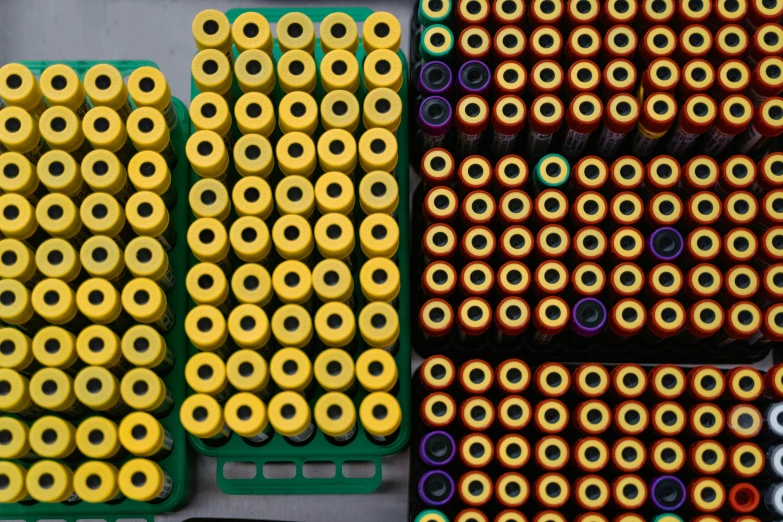 a table topped with lots of different types of batteries, inspired by Andreas Gursky, process art, yellow purple green, shot on canon eos r 5, many pipes, concentric circles