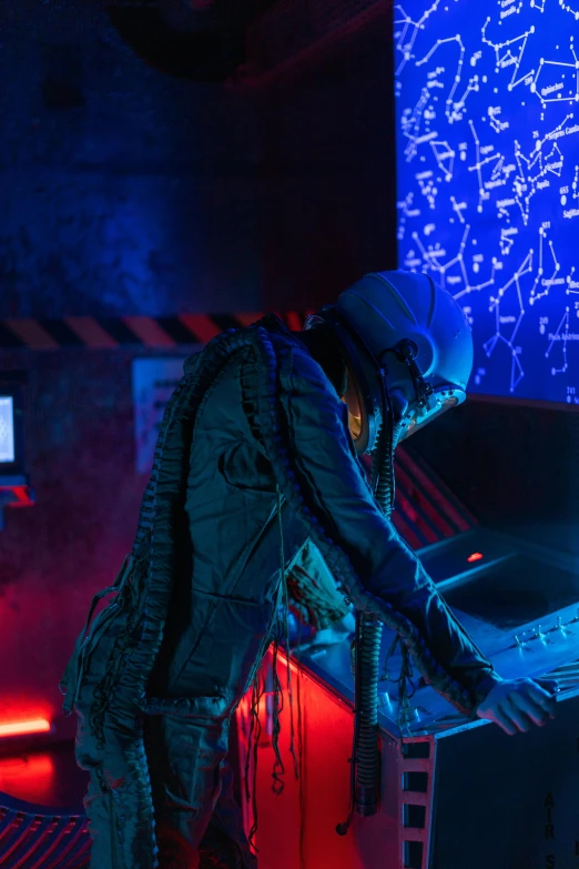 a man that is standing in front of a computer, cyberpunk art, inspired by roger deakins, pexels, keyboardist, futuristic clothing and helmet, cinematic blue lighting, music being played