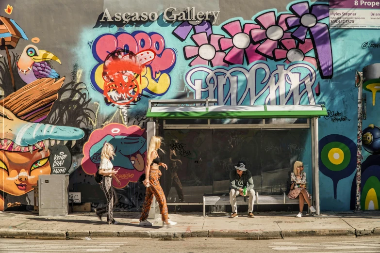 a group of people walking down a street next to a building, street art, avatar image, vaccaro, south beach colors, ap photography