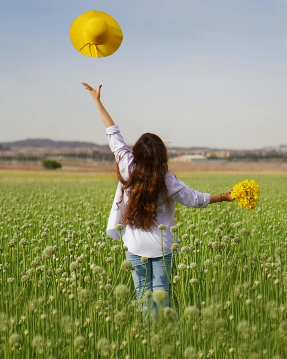 a woman throwing a yellow frisbee in a field, a picture, pexels contest winner, color field, holding flowers, holding an umbrella, overlooking, hugging