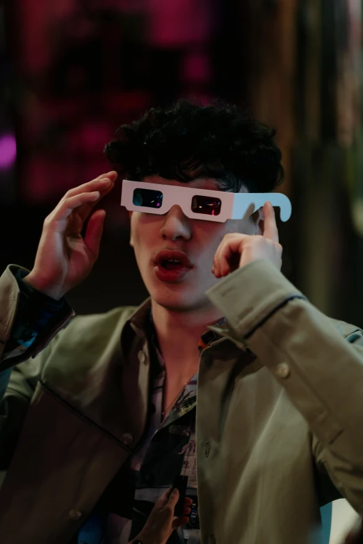 a man wearing a pair of glasses while talking on a cell phone, a hologram, trending on pexels, holography, finn wolfhard, eyes projected onto visor, 3 d movie still, nightlife