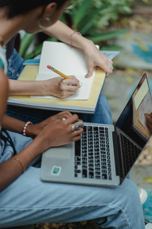 a group of people sitting on a bench with laptops, trending on pexels, academic art, holding pencil, half image, julia sarda, photograph credit: ap