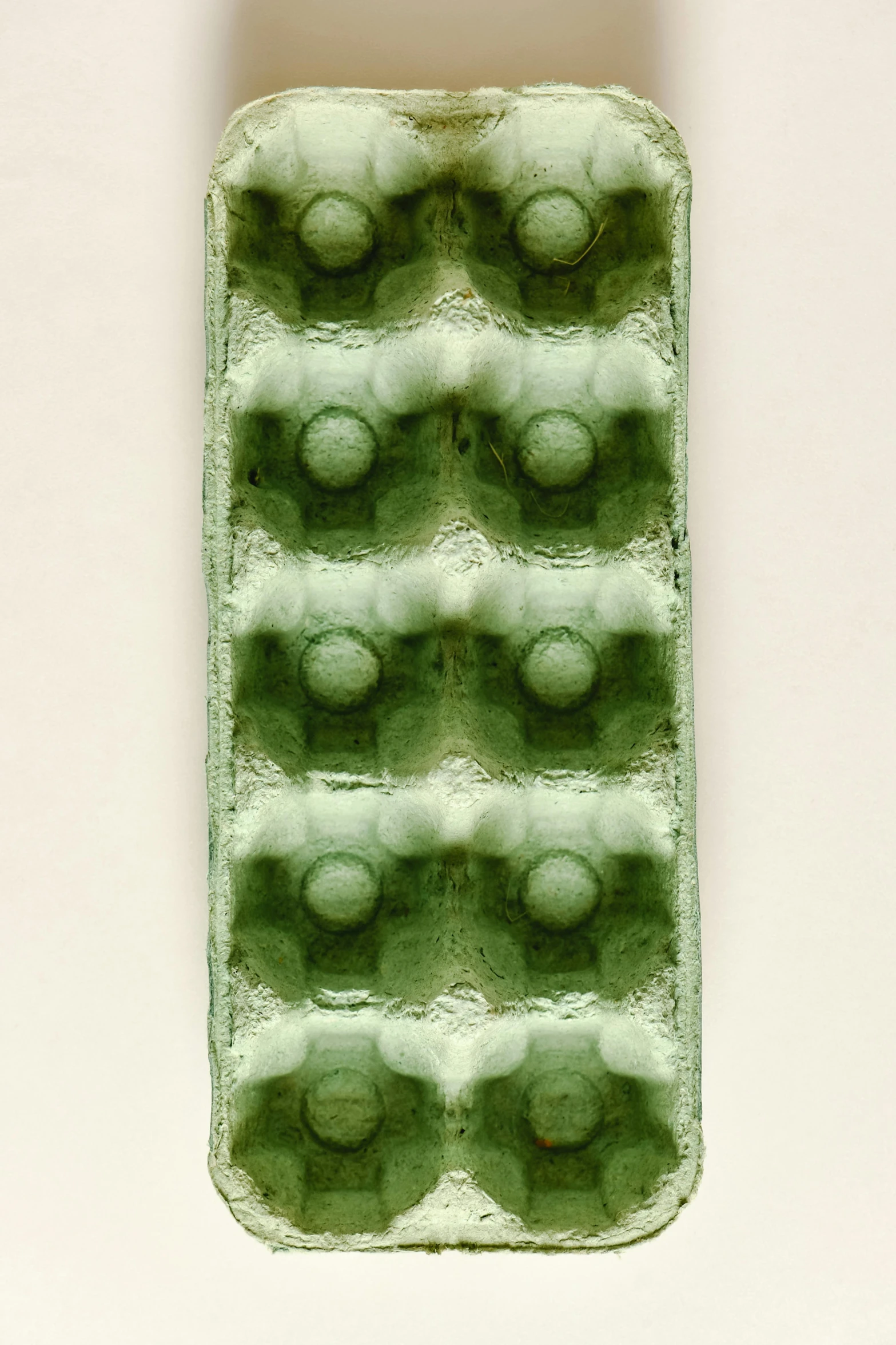 a close up of a cell phone case on a table, by Doug Ohlson, modernism, cast glass, green pupills, 1970', made of glazed