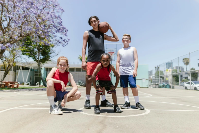 a group of children standing on top of a basketball court, a portrait, by Gavin Hamilton, pexels contest winner, wearing shorts, 15081959 21121991 01012000 4k, portrait of tall, lachlan bailey