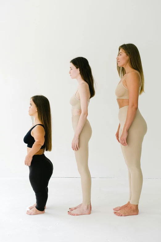 a group of women standing next to each other, inspired by Vanessa Beecroft, instagram, renaissance, bent - over posture, measurements, designer product, compression