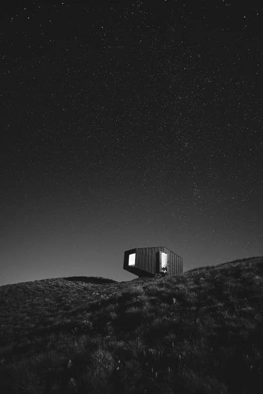 a house sitting on top of a hill under a night sky, a black and white photo, unsplash contest winner, conceptual art, lit. 'the cube', ffffound, tiny spaceship, pose 4 of 1 6