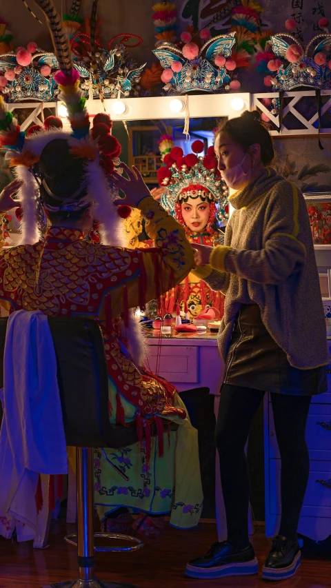 a group of people standing around a table, peking opera, glow, at home, holiday season