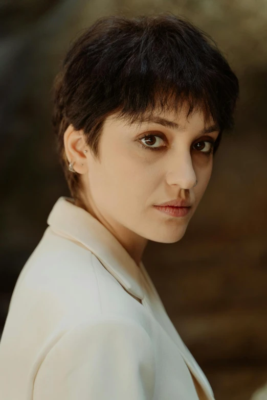 a woman in a white jacket posing for a picture, an album cover, by irakli nadar, pixie cut, portrait of the actress, 8k 50mm iso 10, maria fortuny