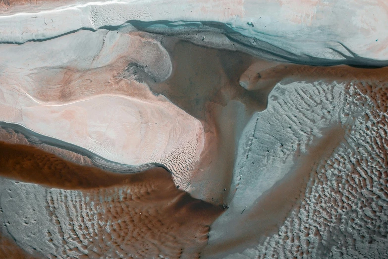 a large body of water sitting on top of a sandy beach, inspired by Anna Füssli, unsplash contest winner, land art, seen from space, mountains of ice cream, martian architecture, 8k detail