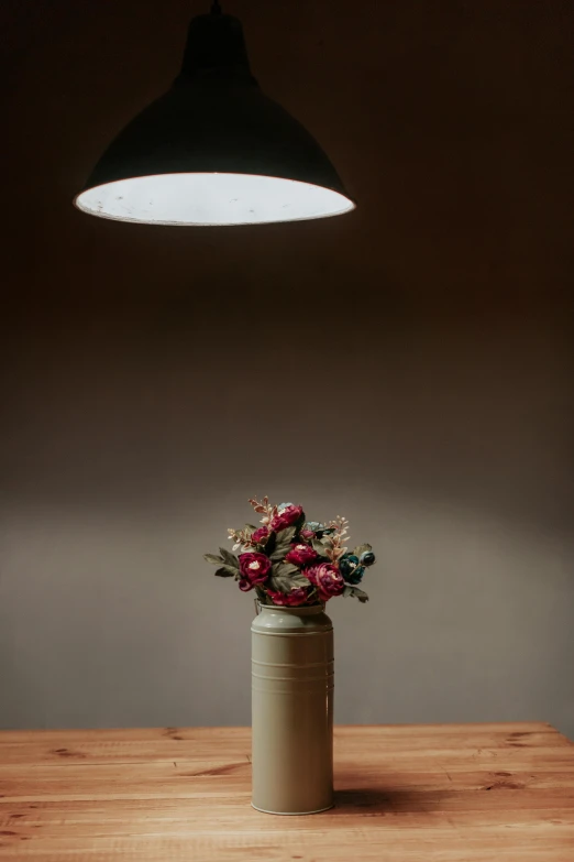 a wooden table topped with a vase filled with flowers, a still life, unsplash, atmospheric lighting - n 9, indoor dim light, made of glazed, seasonal