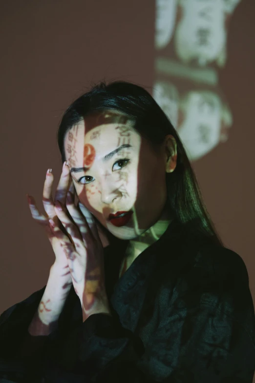 a woman standing in front of a projection screen, inspired by Taro Yamamoto, unsplash, hands on face, chinese heritage, ((portrait)), concert