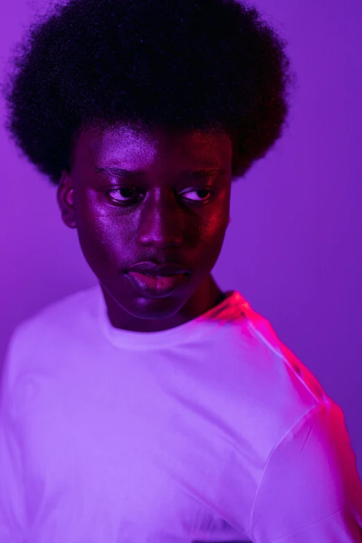 a man standing in front of a purple light, pexels contest winner, afrofuturism, black man with afro hair, black teenage girl, barely lit warm violet red light, an all white human