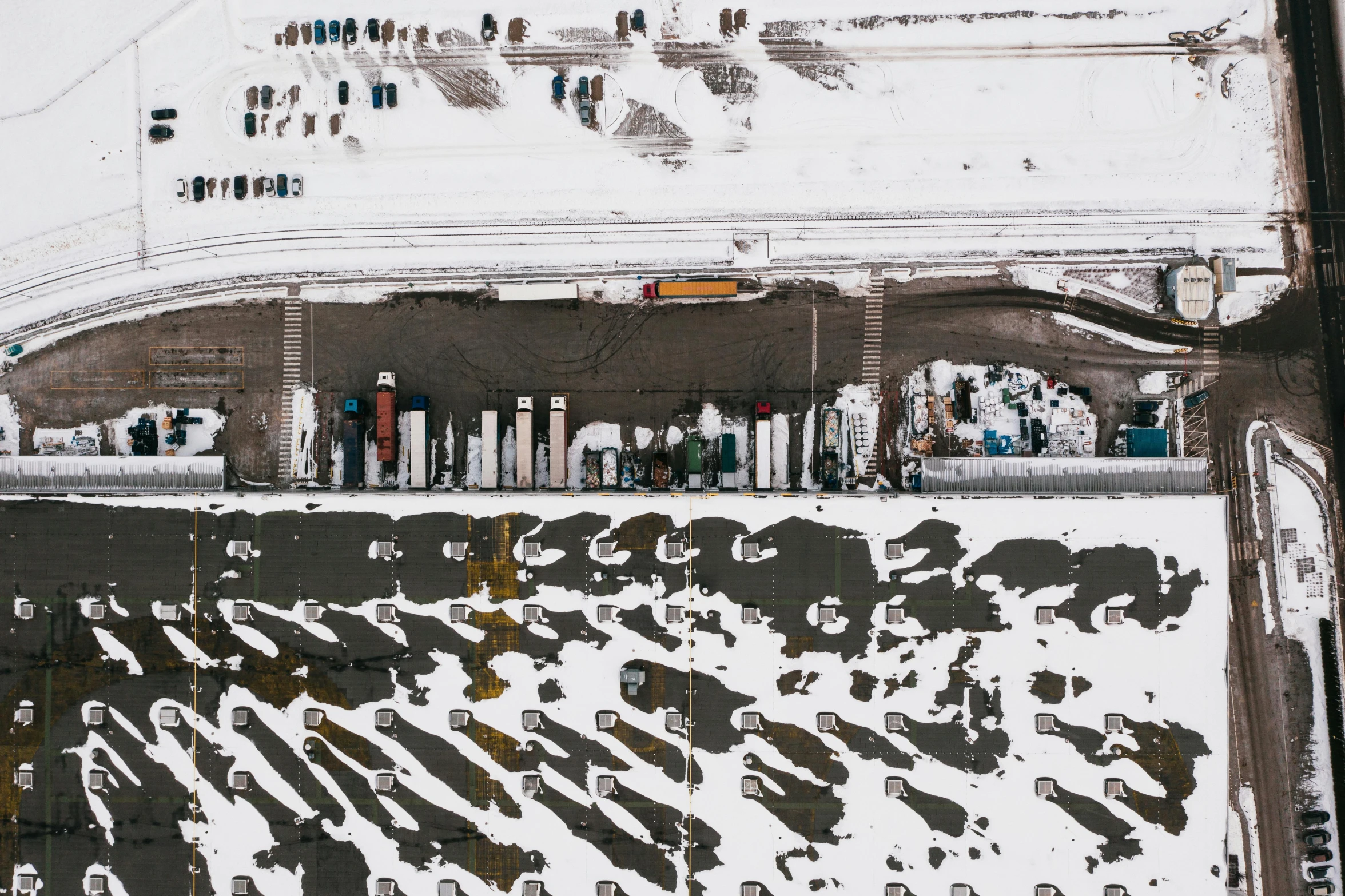 an aerial view of a parking lot covered in snow, inspired by Andreas Gursky, pexels contest winner, land art, shipping containers, people on the ground, norilsk, thumbnail