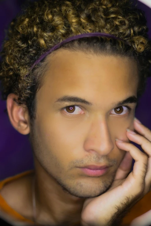 a close up of a person talking on a cell phone, inspired by Robbie Trevino, renaissance, curly and short top hair, purple scene lighting, handsome attractive face, ariel perez