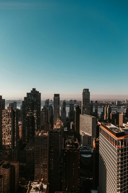 a view of a city from the top of a building, new york city skyline, clear blue skies, 2019 trending photo, ultrawide landscape