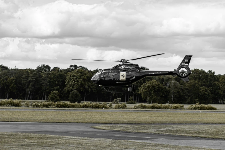 a black and white photo of a helicopter taking off, by Tom Bonson, pexels contest winner, hurufiyya, striking colour, vehicle, celebrity, hd footage
