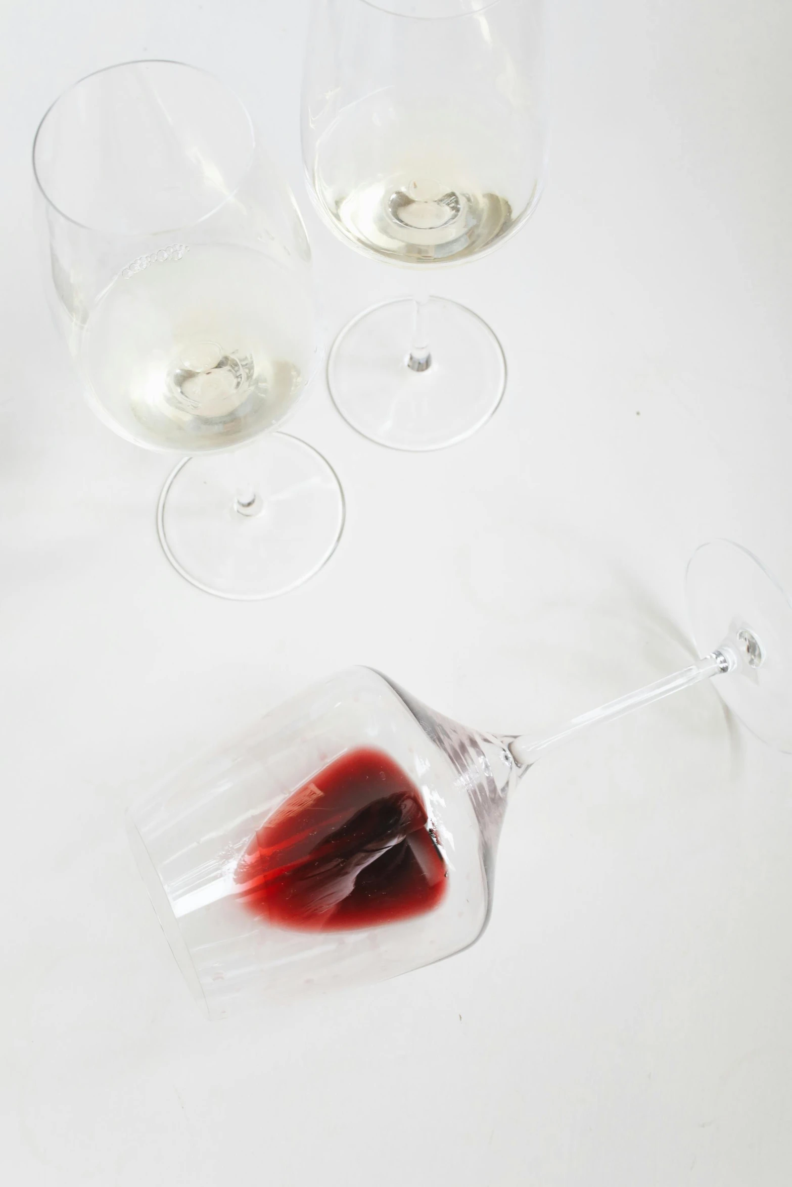 a couple of wine glasses sitting on top of a table, crying blood, julia hetta, detail shot, with white