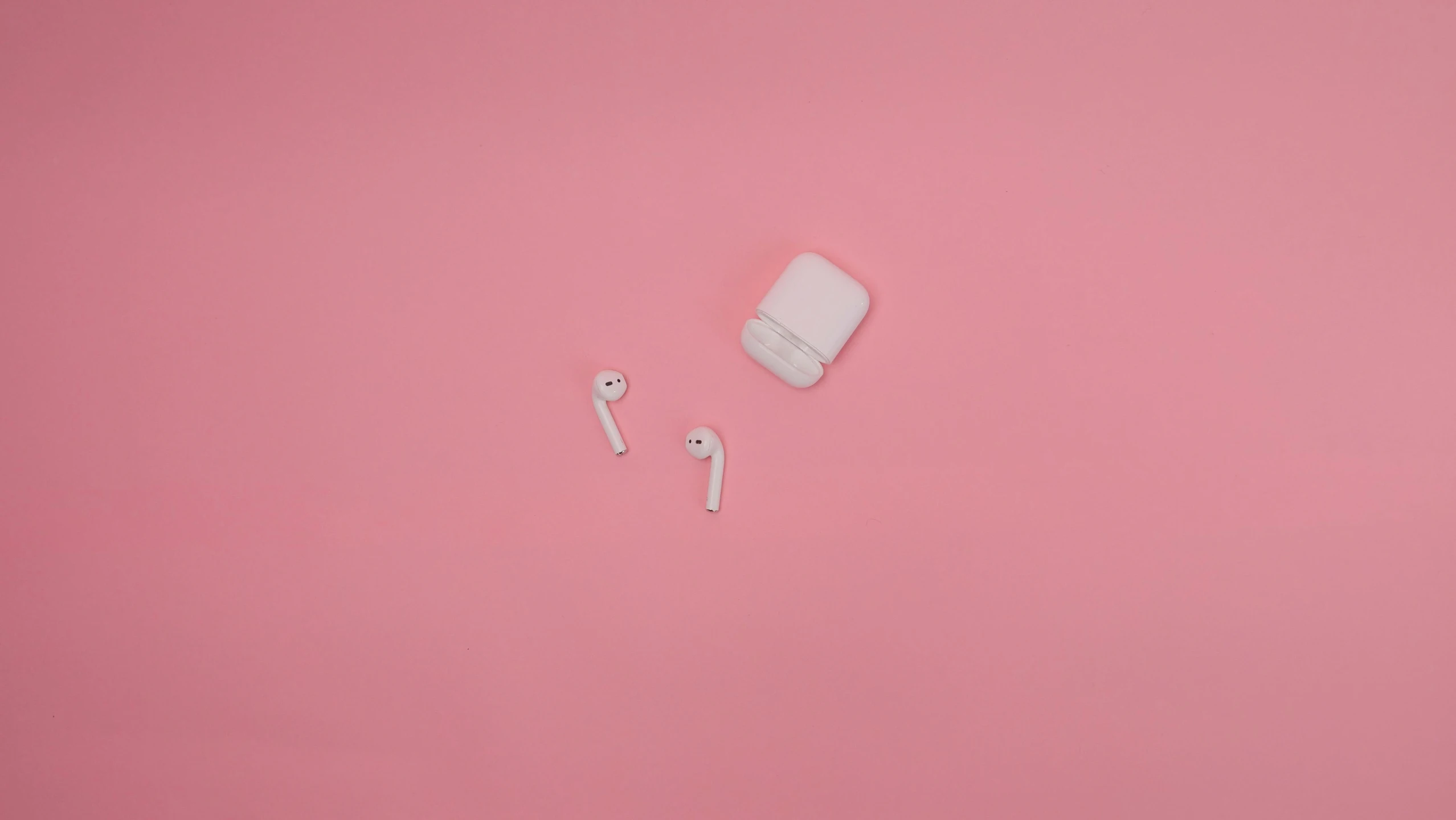 a pair of ear buds sitting on top of a pink surface, trending on pexels, white sleeves, drones, 1787, milk