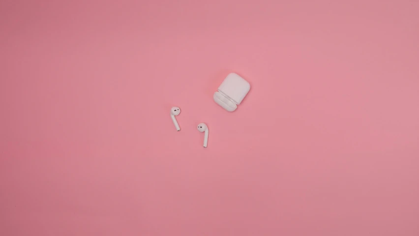 a pair of ear buds sitting on top of a pink surface, trending on pexels, white sleeves, drones, 1787, milk