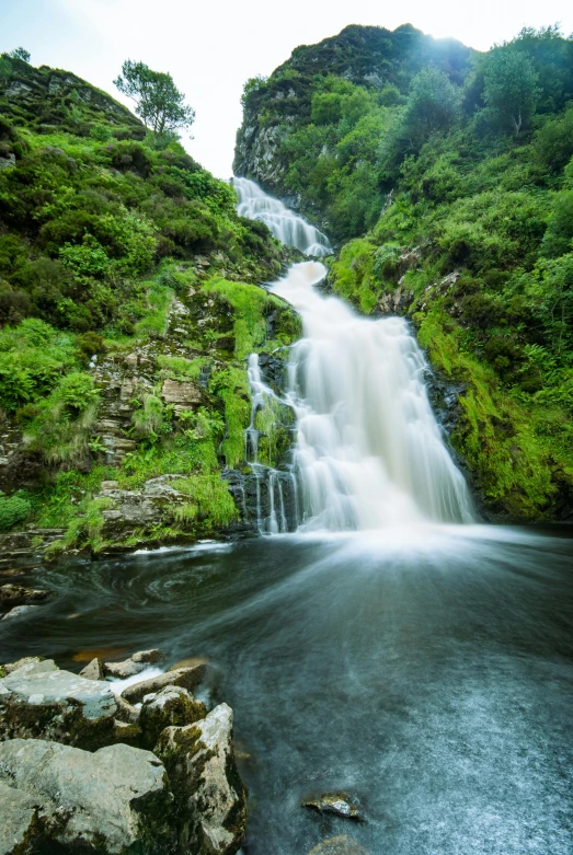 a waterfall in the middle of a lush green forest, skye meaker, deep clear pools of water, thumbnail, snacks