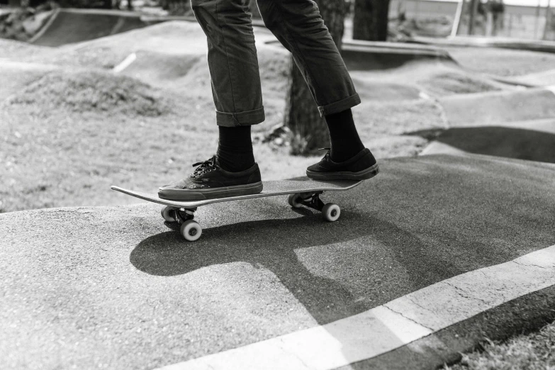 a black and white photo of a person on a skateboard, gray shorts and black socks, 15081959 21121991 01012000 4k, high quality wallpaper, medium height