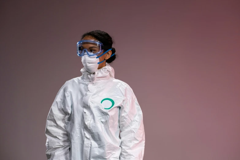 a person wearing a protective suit and goggles, by Olivia Peguero, plasticien, enso, white and teal garment, 8 k what, essence