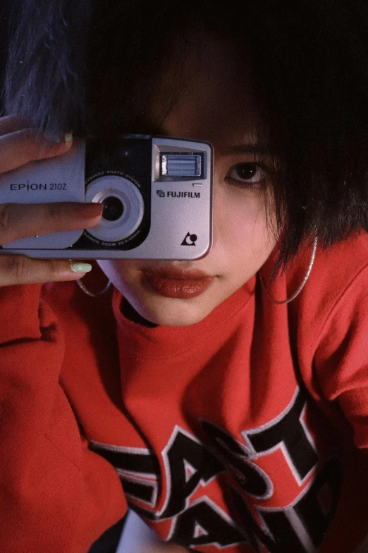 a person taking a picture with a camera, inspired by Nan Goldin, unsplash, photorealism, y 2 k cutecore clowncore, cruel korean goth girl, red, hip hop aesthetic