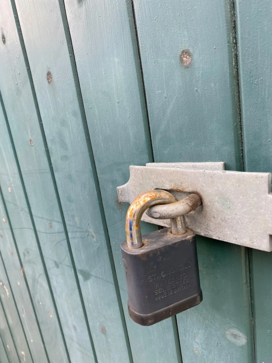 a close up of a padlock on a door, by Tony Tuckson, temporary art, 👰 🏇 ❌ 🍃, sitting down, ready to eat, fencing