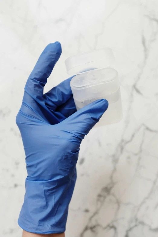 a person in blue gloves holding a plastic container, made of lab tissue, smooth marble surfaces, partially biomedical design, pictured from the shoulders up