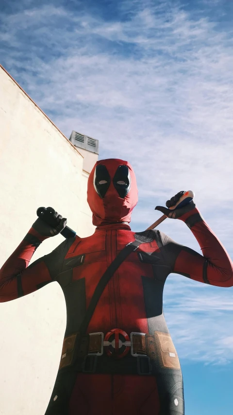 a man dressed as a deadpool poses for a picture, by Drew Tucker, pexels, pop art, lomography photo, instagram story, hero, lycra costume