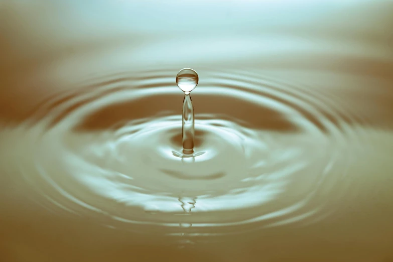 a drop of water falling into a body of water, pexels, renaissance, smooth surface render, brown, shallow focus background, high quality product image”