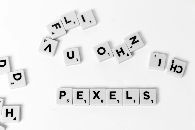 a white table topped with scrabbles and letters, pixel art, by Kristian Zahrtmann, pexels, white background!!!!!!!!!!, we'll fall to pieces, macro details, ernst haekel
