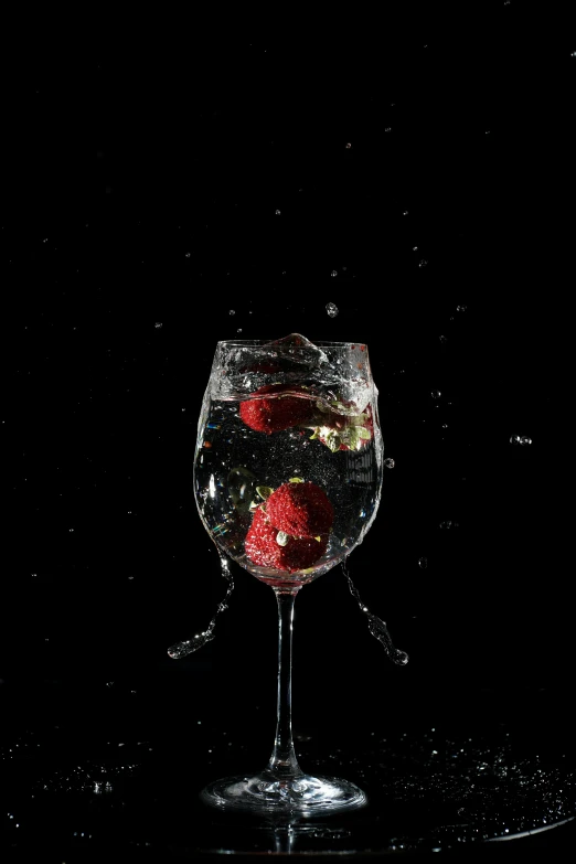 a glass of water with strawberries in it, an album cover, by Ndoc Martini, pexels, standing with a black background, bubbly scenery, bubbly underwater scenery, wine