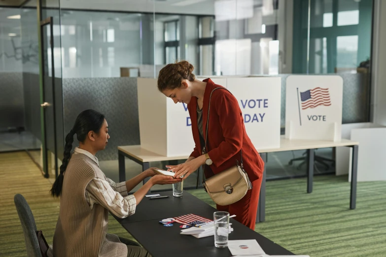 a woman shaking hands with another woman at a table, by Kurt Roesch, shutterstock contest winner, patriotism, hbo, prize winning color photo, presidental elections candidates