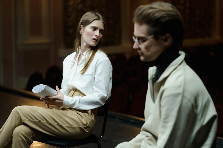a woman sitting on top of a chair next to a man, pexels contest winner, [ theatrical ], wearing a light shirt, aleksandra waliszewska, thumbnail