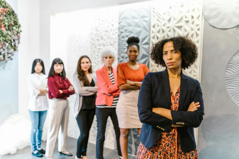 a group of women standing next to each other, in an office, serious composure, realistic »