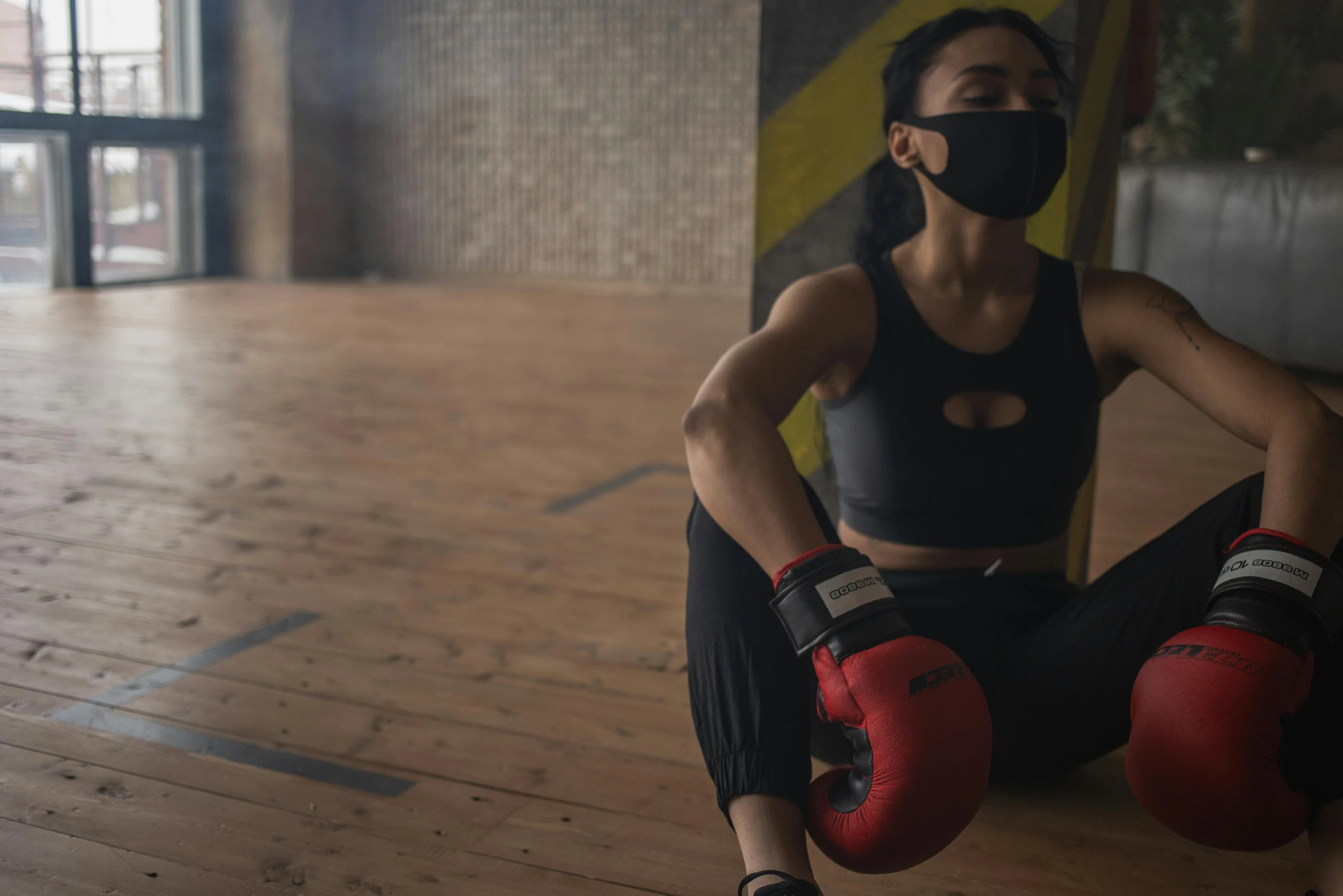 a woman in a black top and red boxing gloves, pexels contest winner, masked person in corner, sitting down casually, avatar image, athletic crossfit build